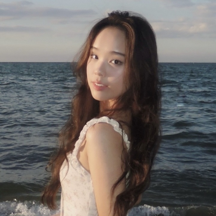Young woman with long brown hair at the beach.