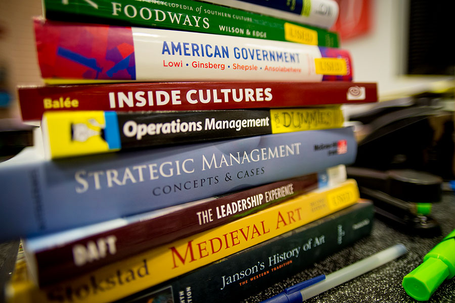 Stack of School of Liberal Arts textbooks.