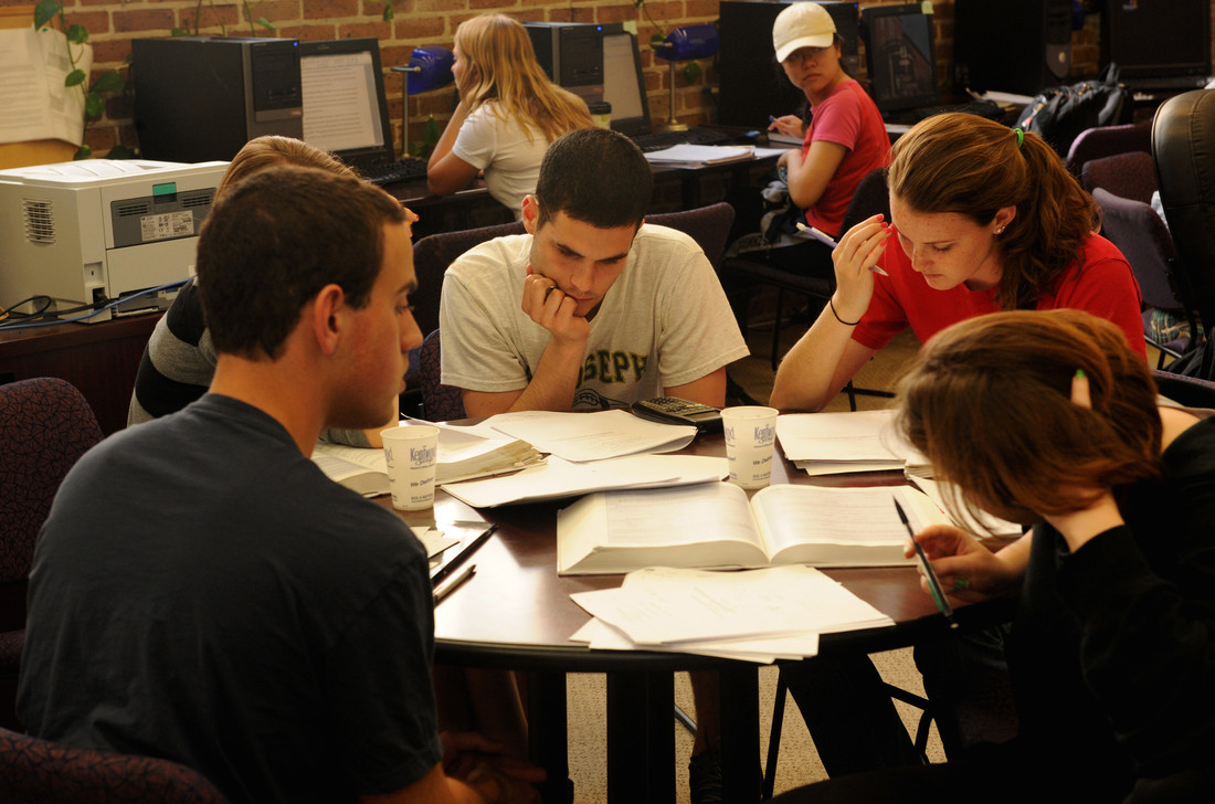 Students in the tutoring center studying at a table.