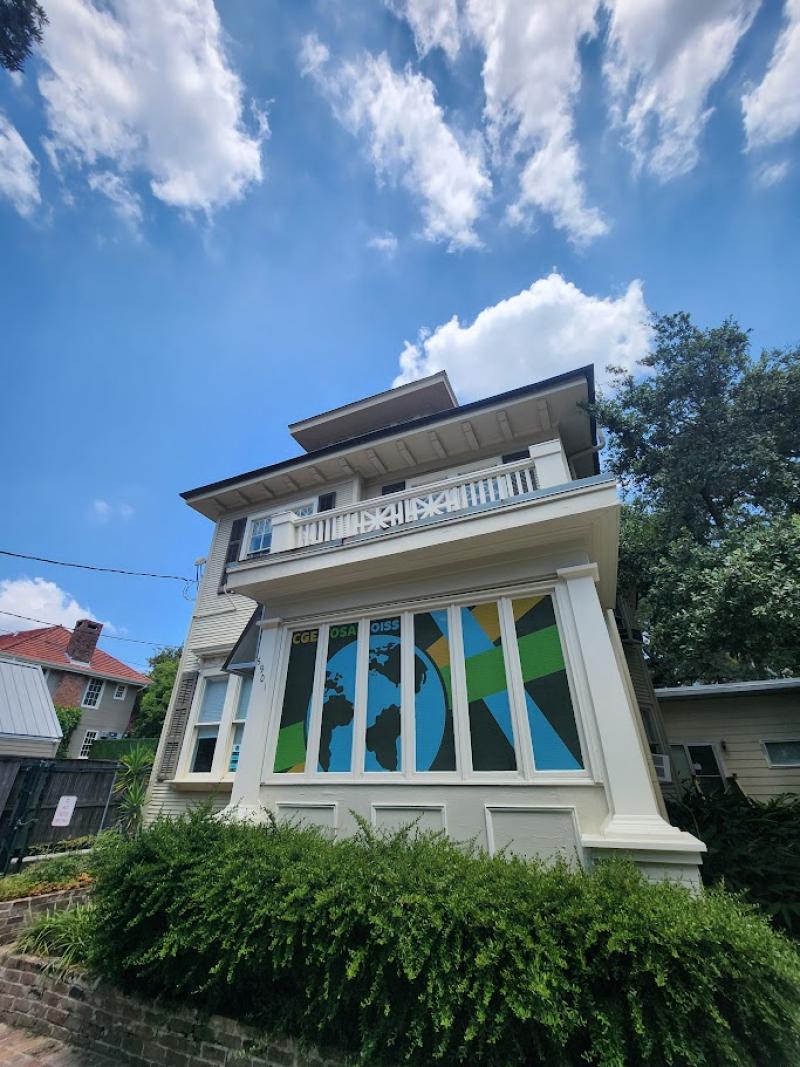 6901 Willow Street house; white building with a globe decal on the windows and blue sky background