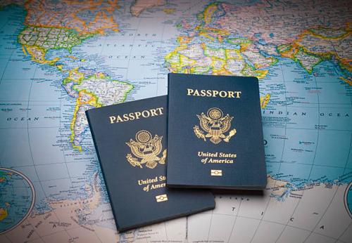 Two US passports on a world map. 