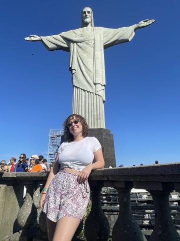 woman standing by cristo redentor statue