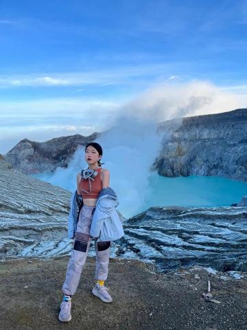 woman standing by blue lagoon