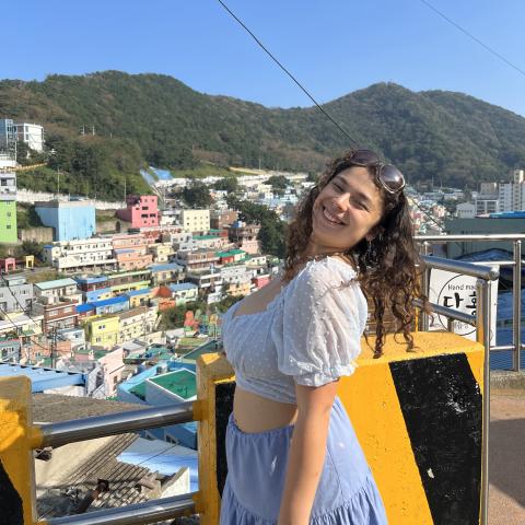 Woman smiling in front of city