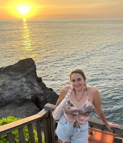 woman smiling in front of sunset