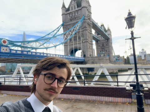 selfie of man smiling by bridge