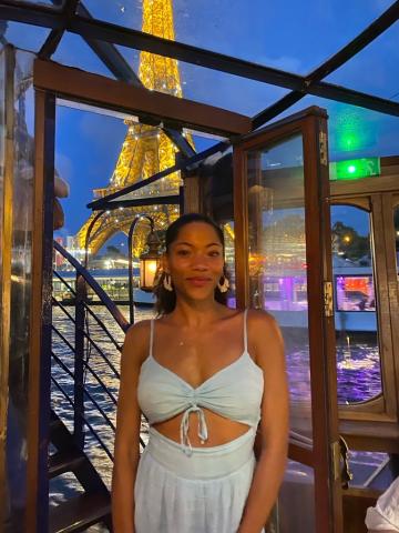 woman smiling in front of Eiffel tower 