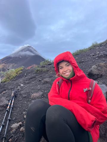 woman in red rain coat on hike