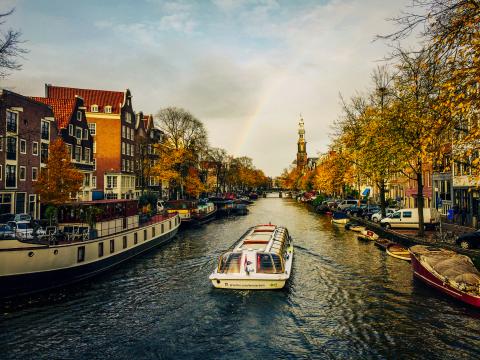 Scenic view of river with a rainbow.